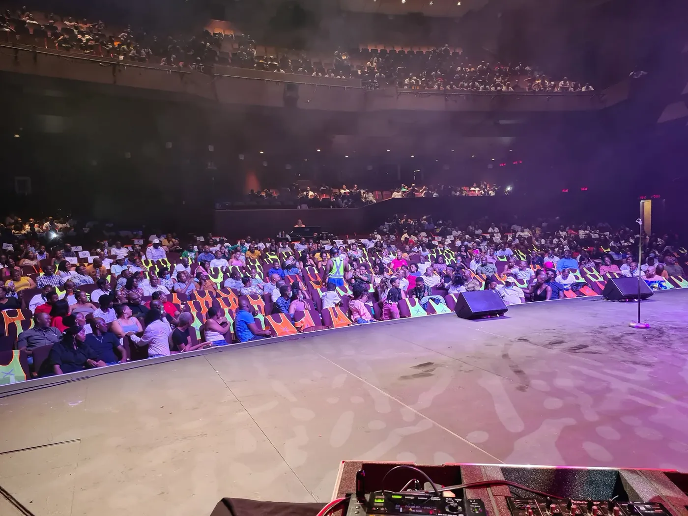 A packed theatre seen from the stage